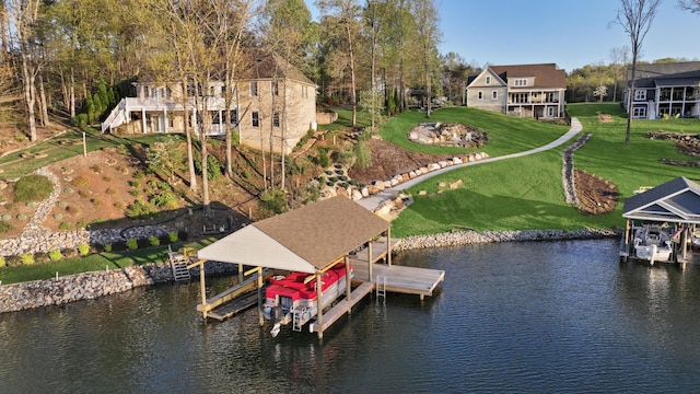 dock area with a water view, a lawn, and boat lift