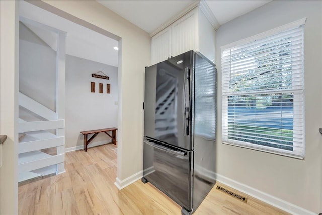 1791 Windlass Rd, Moneta, VA 24121 - kitchen featuring baseboards, white cabinets, light wood-style floors, and freestanding refrigerator