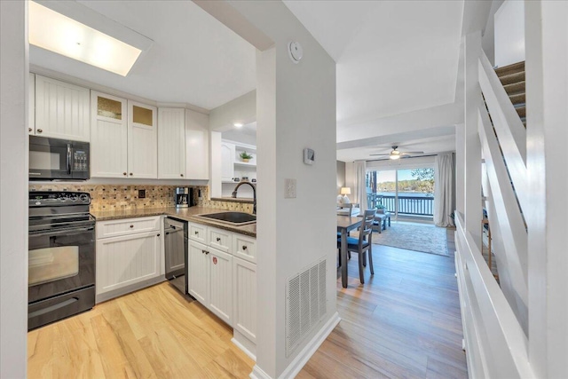 1791 Windlass Rd, Moneta, VA 24121 - kitchen featuring tasteful backsplash, light wood-style flooring, a sink, visible vents, and black appliances