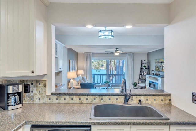 1791 Windlass Rd, Moneta, VA 24121 - kitchen with a sink, a ceiling fan, backsplash, white cabinetry, and dishwasher