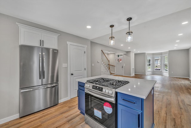 535 Day Ave SW, Roanoke, VA 24016 - kitchen with light wood-type flooring, appliances with stainless steel finishes, blue cabinetry, and white cabinets