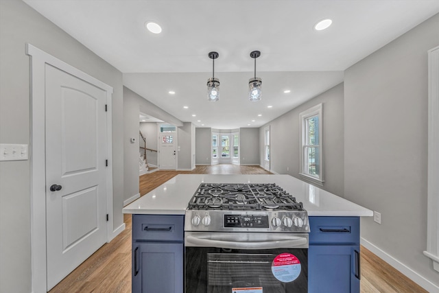 535 Day Ave SW, Roanoke, VA 24016 - kitchen featuring light countertops, blue cabinets, light wood-type flooring, and stainless steel range with gas cooktop