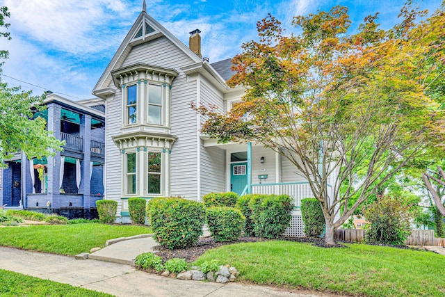 535 Day Ave SW, Roanoke, VA 24016 - victorian home featuring a chimney and covered porch