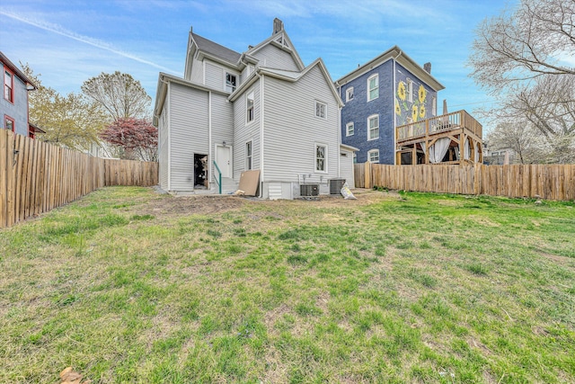 535 Day Ave SW, Roanoke, VA 24016 - back of property featuring central AC unit, a fenced backyard, a yard, and a chimney