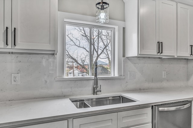 535 Day Ave SW, Roanoke, VA 24016 - kitchen featuring pendant lighting, stainless steel dishwasher, white cabinets, a sink, and backsplash