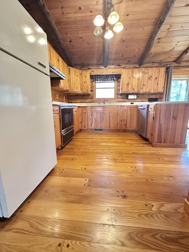 kitchen featuring electric range oven, dishwasher, freestanding refrigerator, under cabinet range hood, and light wood-style flooring