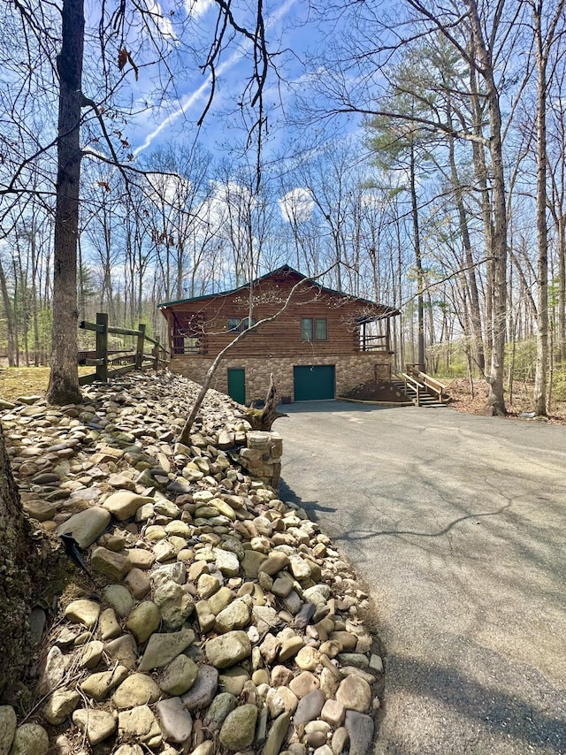 view of side of home featuring aphalt driveway