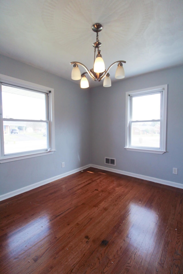 2048 Laura Rd NW, Roanoke, VA 24017 - spare room featuring a chandelier, plenty of natural light, visible vents, and dark wood-style flooring