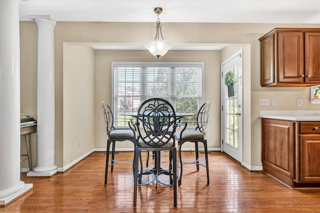 6206 Stone Manor Dr, Roanoke, VA 24018 - dining room featuring ornate columns, wood-type flooring, and baseboards
