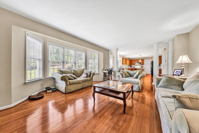 6206 Stone Manor Dr, Roanoke, VA 24018 - living room with ornate columns and light wood-style floors