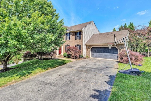 6206 Stone Manor Dr, Roanoke, VA 24018 - view of front of home with an attached garage, asphalt driveway, a front yard, and brick siding