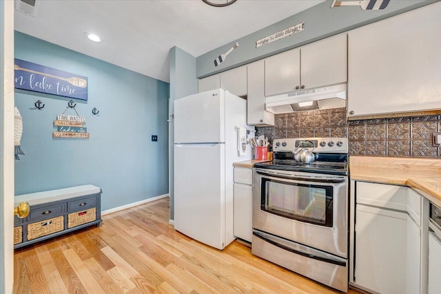 114 Waterside Cir Unit B-6, Moneta, VA 24121 - kitchen with under cabinet range hood, stainless steel range with electric stovetop, freestanding refrigerator, light countertops, and tasteful backsplash
