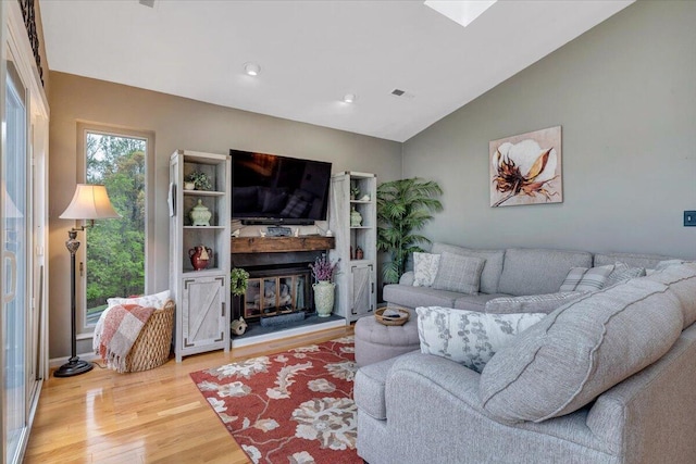 114 Waterside Cir Unit B-6, Moneta, VA 24121 - living area with light wood-type flooring, vaulted ceiling, a glass covered fireplace, and recessed lighting