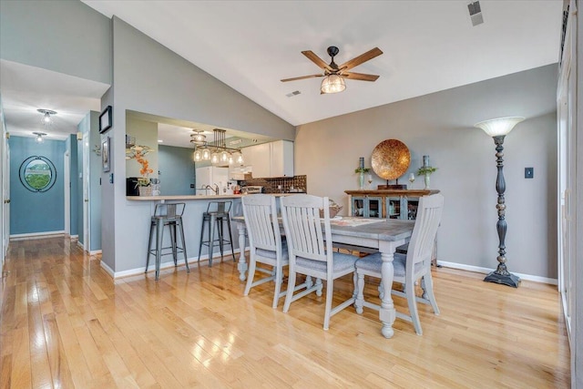 114 Waterside Cir Unit B-6, Moneta, VA 24121 - dining room featuring a ceiling fan, light wood-style flooring, vaulted ceiling, baseboards, and a chandelier
