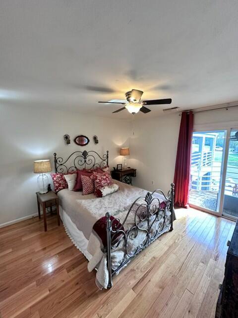114 Waterside Cir Unit B-6, Moneta, VA 24121 - bedroom with access to outside, wood finished floors, a ceiling fan, and baseboards