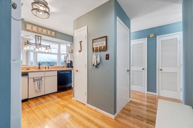 114 Waterside Cir Unit B-6, Moneta, VA 24121 - kitchen featuring dishwasher, light wood-type flooring, a sink, light countertops, and white cabinets