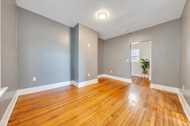 empty room with light wood-style floors and baseboards