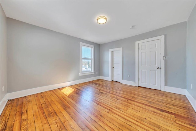 unfurnished bedroom featuring light wood-style flooring and baseboards