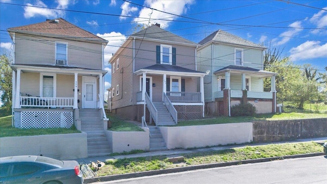 view of front facade featuring stairs and covered porch