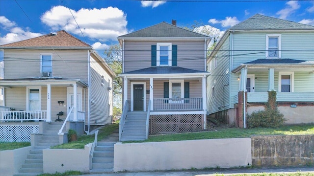 view of front of house featuring stairway and covered porch