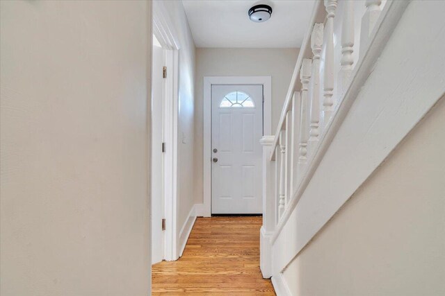doorway to outside featuring light wood-style floors and stairs