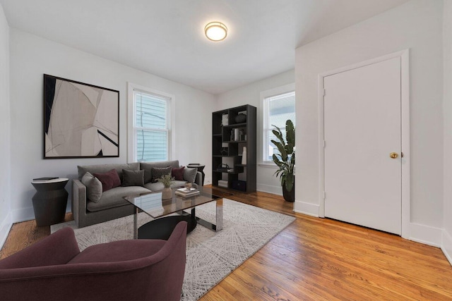 living area featuring light wood finished floors and baseboards