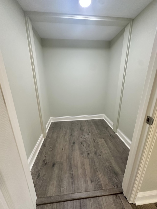 interior space with baseboards and dark wood-style floors