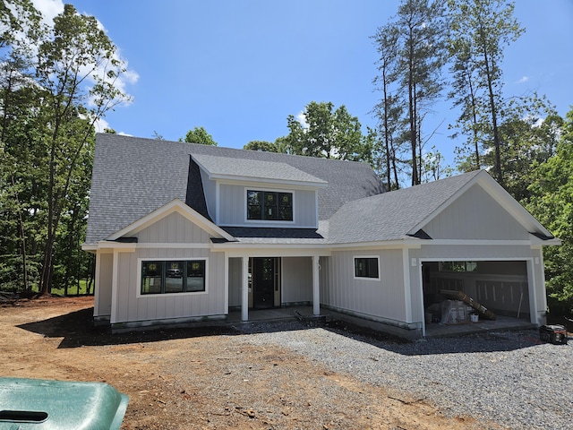 120 Pointe O Woods Dr, Huddleston, VA 24104 - modern farmhouse with an attached garage, a shingled roof, covered porch, and gravel driveway