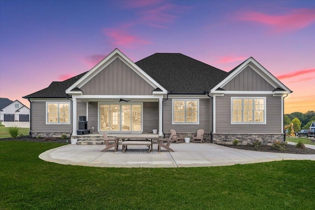 120 Pointe O Woods Dr, Huddleston, VA 24104 - back of house at dusk featuring a lawn, ceiling fan, board and batten siding, and a patio area
