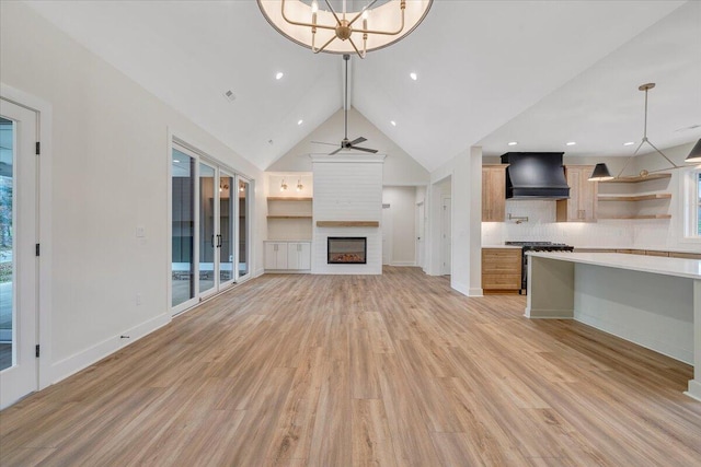 120 Pointe O Woods Dr, Huddleston, VA 24104 - unfurnished living room with a fireplace, light wood finished floors, a ceiling fan, baseboards, and vaulted ceiling