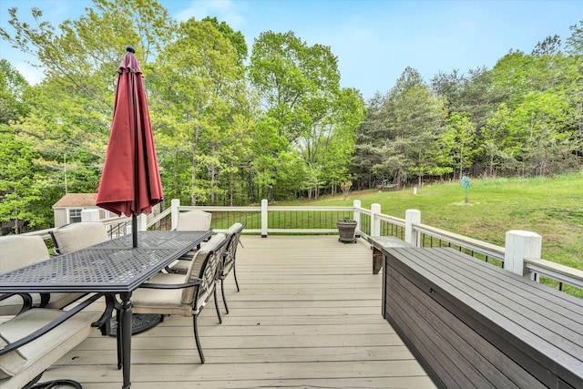 wooden deck with outdoor dining space and a lawn