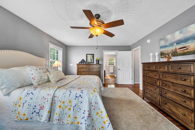 bedroom featuring baseboards, a ceiling fan, and dark wood-style floors