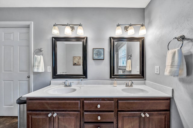 bathroom featuring a sink and double vanity