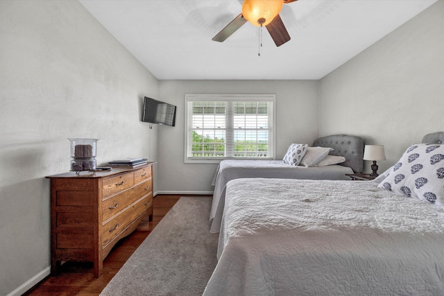 bedroom with baseboards, ceiling fan, and dark wood-style flooring