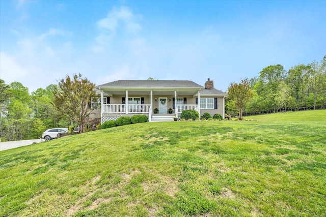 ranch-style home with a chimney, a front lawn, and covered porch