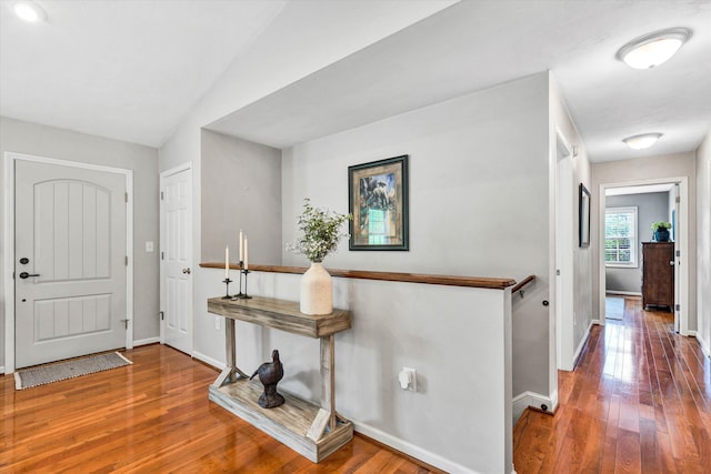 foyer featuring baseboards and hardwood / wood-style floors
