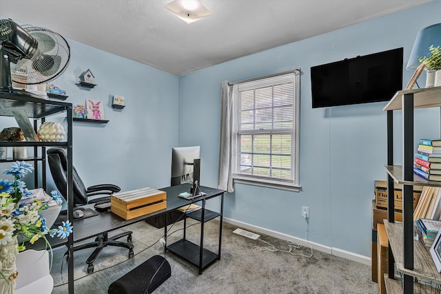 carpeted office space with baseboards and visible vents