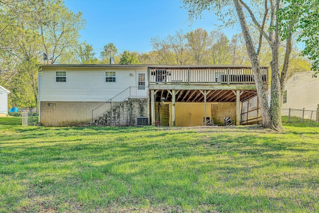 back of property with central air condition unit, stairway, a yard, a deck, and fence