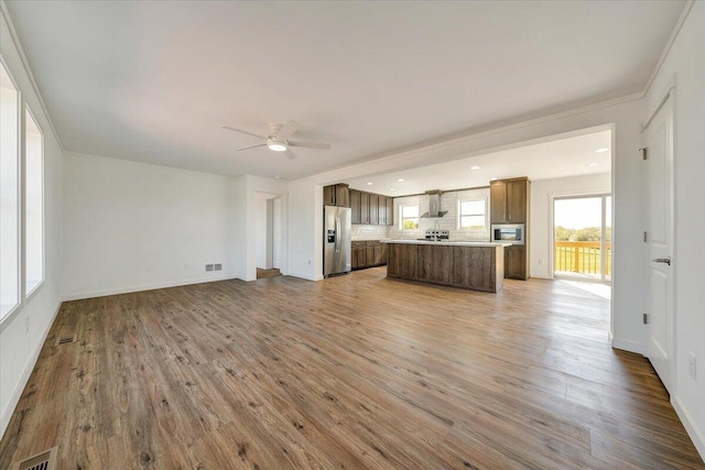 2227 Hendricks Store Rd, Moneta, VA 24121 - kitchen featuring open floor plan, wall chimney exhaust hood, appliances with stainless steel finishes, and wood finished floors