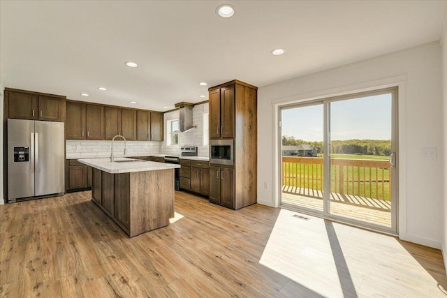 2227 Hendricks Store Rd, Moneta, VA 24121 - kitchen with visible vents, appliances with stainless steel finishes, tasteful backsplash, light countertops, and light wood-style flooring