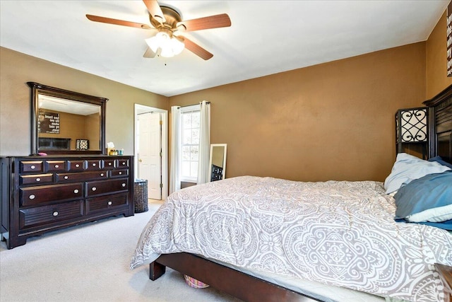 bedroom with ceiling fan and light colored carpet