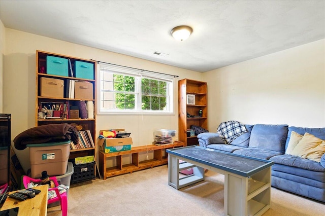 living area featuring carpet flooring and visible vents