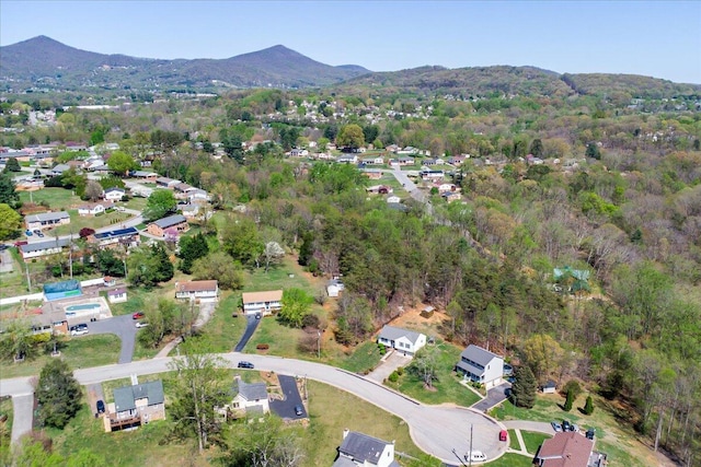 aerial view with a wooded view and a mountain view
