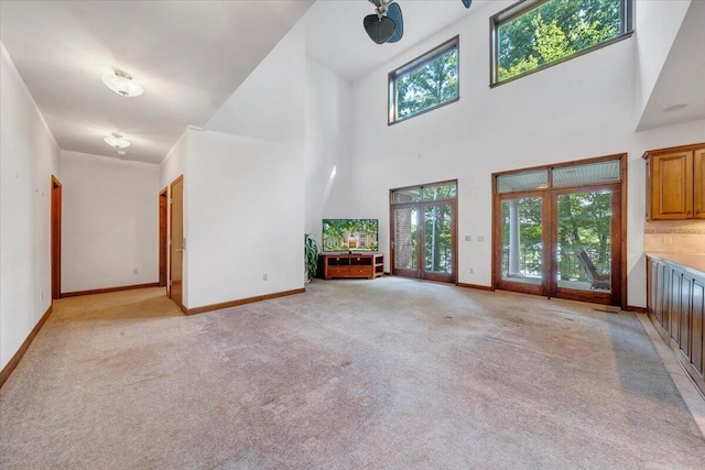 723 Fox Chase Rd, Wirtz, VA 24184 - unfurnished living room with light colored carpet, baseboards, and a towering ceiling
