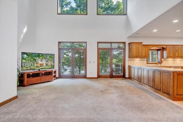 723 Fox Chase Rd, Wirtz, VA 24184 - unfurnished living room with a high ceiling, plenty of natural light, light colored carpet, baseboards, and recessed lighting