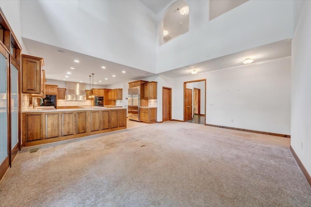 723 Fox Chase Rd, Wirtz, VA 24184 - unfurnished living room with light colored carpet, baseboards, recessed lighting, and a towering ceiling