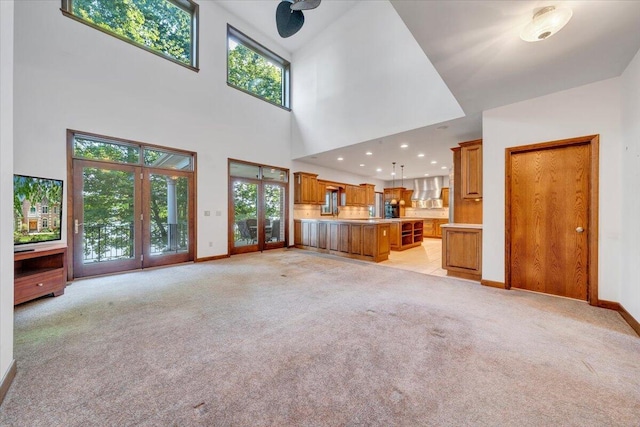 723 Fox Chase Rd, Wirtz, VA 24184 - unfurnished living room featuring french doors, light carpet, baseboards, recessed lighting, and a high ceiling