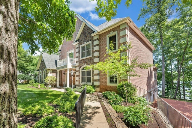 723 Fox Chase Rd, Wirtz, VA 24184 - view of front facade with a balcony, brick siding, a front lawn, and stone siding