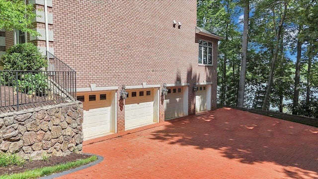 723 Fox Chase Rd, Wirtz, VA 24184 - view of side of home featuring a garage, brick siding, and driveway