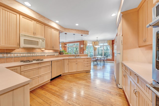 3649 Peakwood Dr SW, Roanoke, VA 24014 - kitchen featuring white appliances, light brown cabinetry, a peninsula, light wood-style flooring, and backsplash